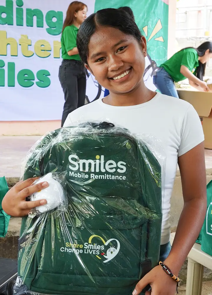 a-student-poses-with-her-school-bag