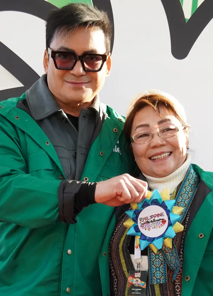 gabby-displays-philippine-festival-badge-with-organizer