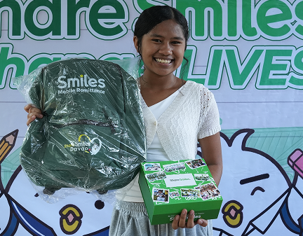 One Million Smiles 2026. Happy student with this year's merchandise.