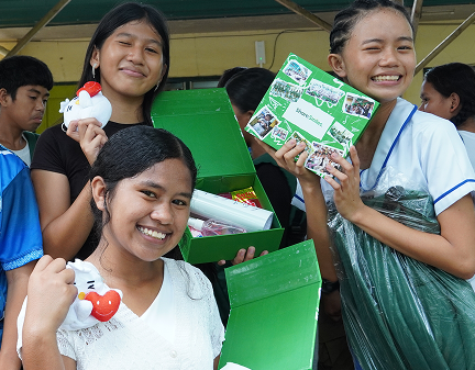 One Million Smiles 2026. A group of students having fun and showing their gifts from Smiles