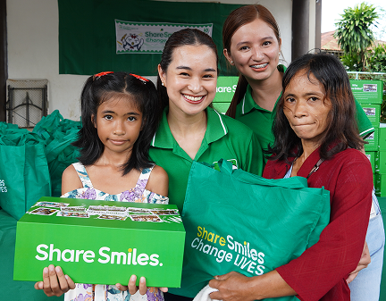 One Million Smiles 2026. Family receiving their Smiles package with the Smiles staff.