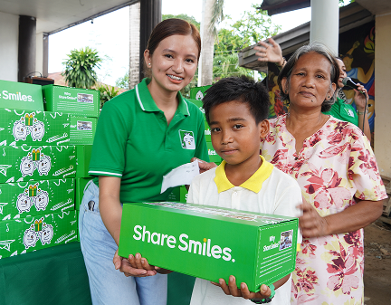One Million Smiles 2026. Student and family receiving their Smiles package
