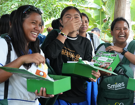 One Million Smiles 2026. A group of students having fun while opening their Smiles box