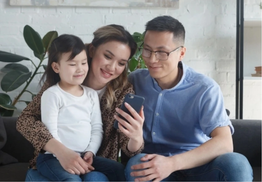 our mission - family of three using smiles app on their smartphones to remit money
