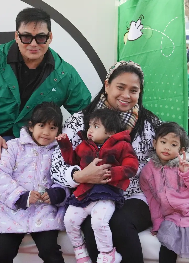 gabby takes a picture with family